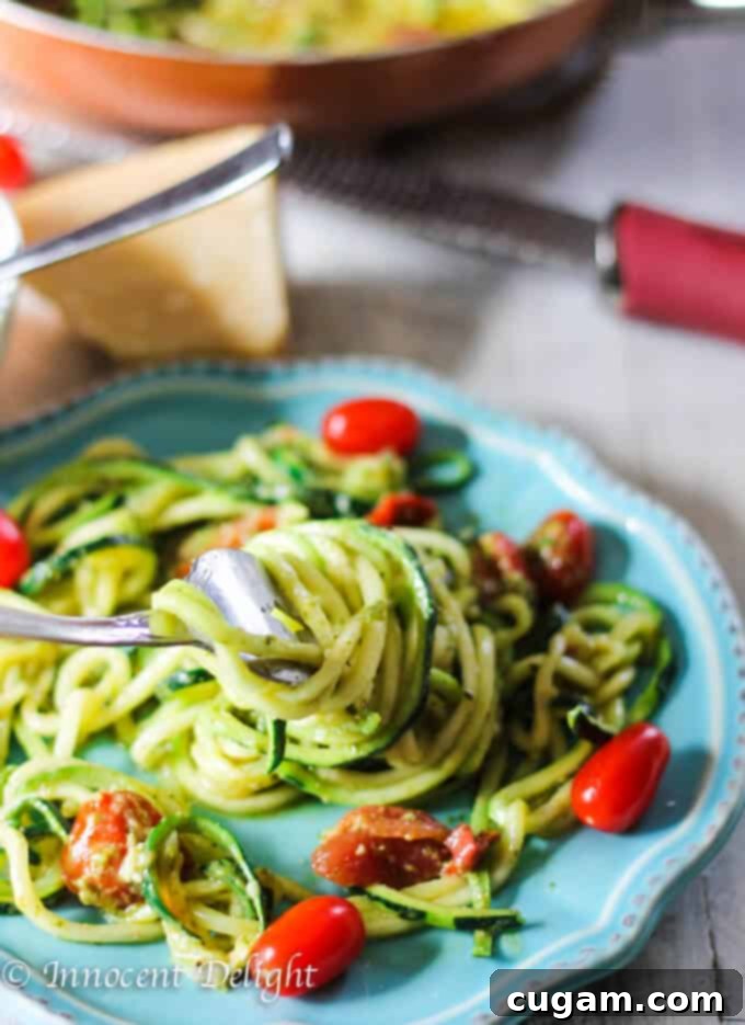 Close-up of the Pesto Zucchini Noodles with Cherry Tomatoes, highlighting the fresh ingredients and vibrant colors.