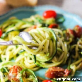 Pesto Zucchini Noodles with Cherry Tomatoes, a quick and delicious recipe.