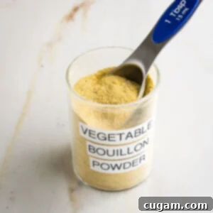 Vegetable Bouillon Powder labeled jar with yellow powdery mix inside plus a Tablespoon measure.
