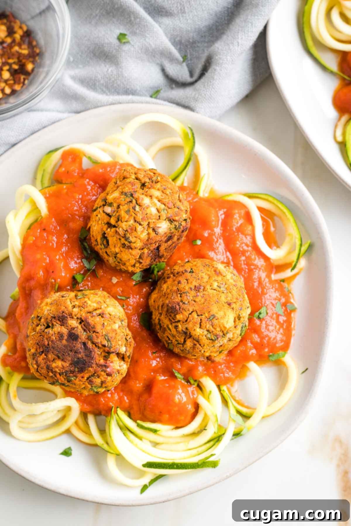 Vegan meatballs over zucchini noodles and marinara sauce.