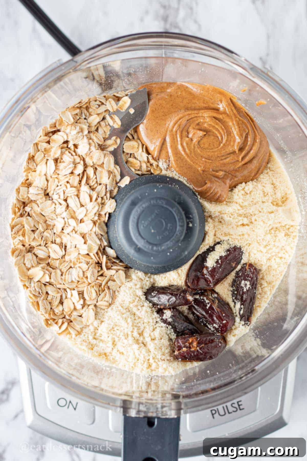 Ingredients for almond butter protein balls in food processor.