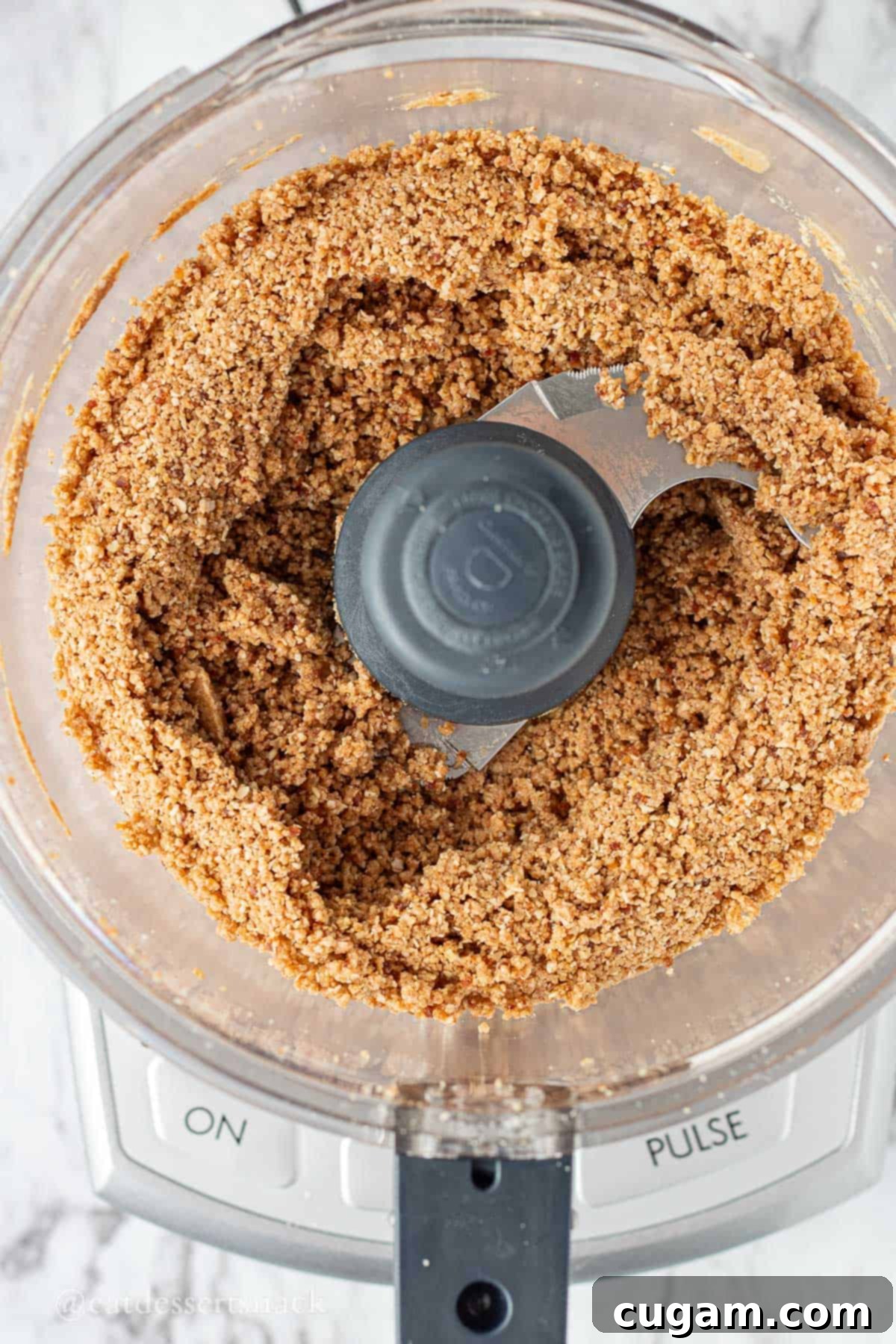 Mixed almond oats, almond flour, honey, almond butter, protein powder, honey, and vanilla in bowl of food processor.