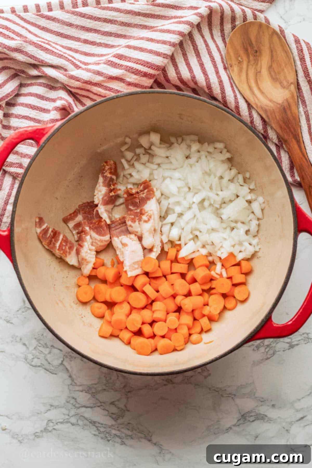 Raw carrots, onions, and bacon are shown cooking in a large red pot over medium heat.