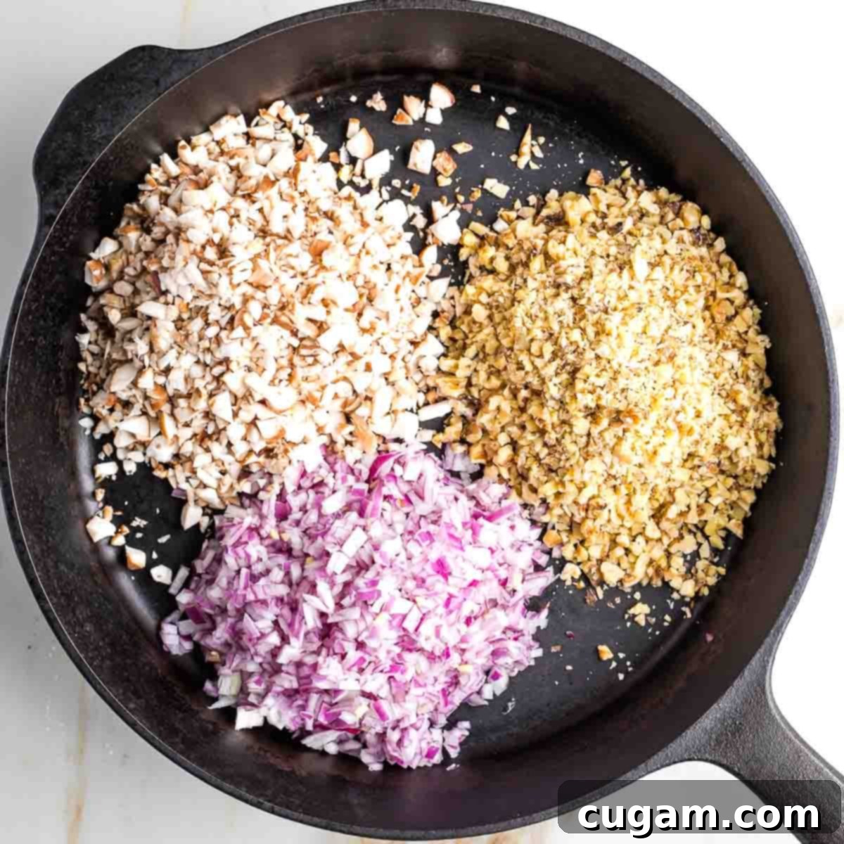 Mincing onions, mushrooms, and walnuts for vegan ground beef.