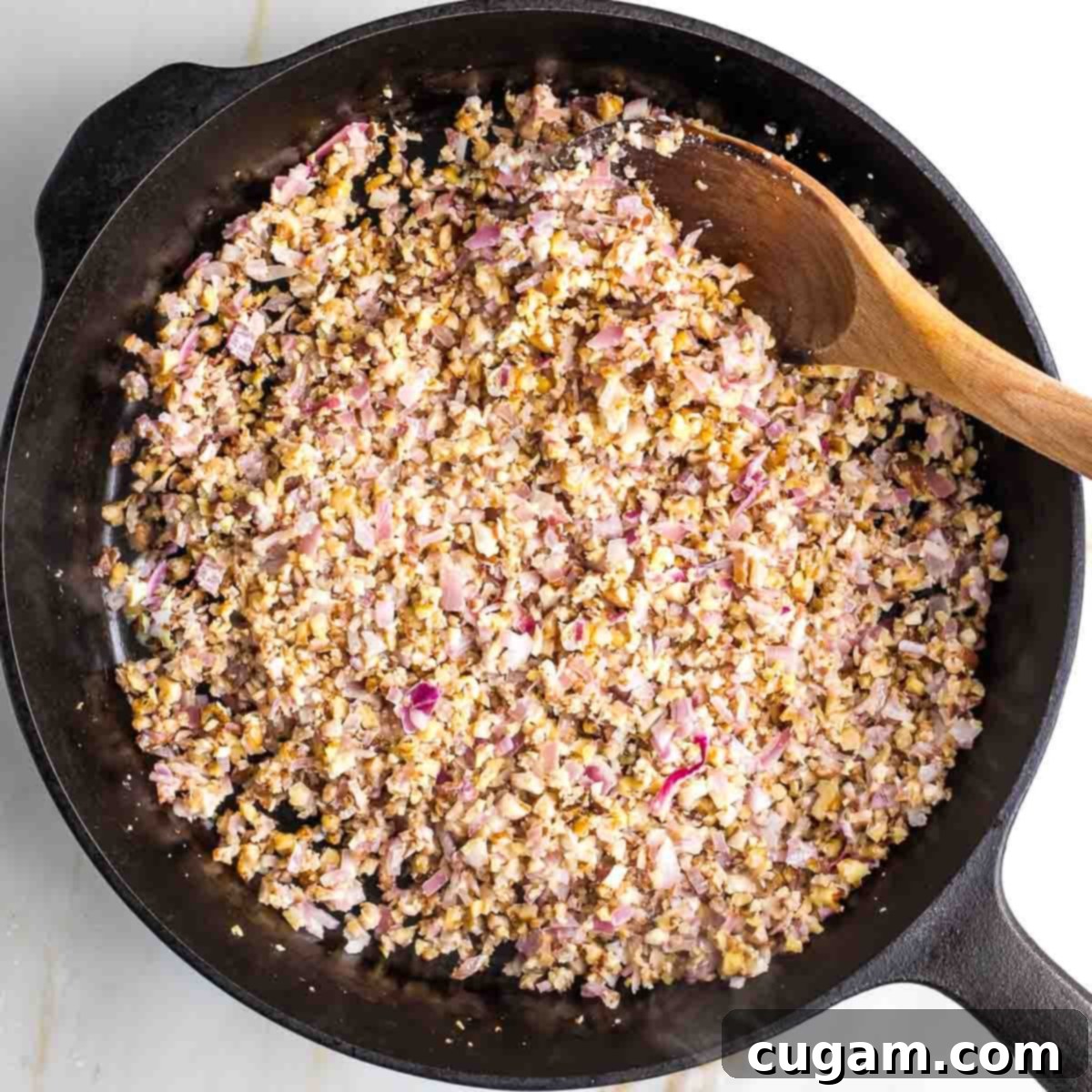 Sautéing minced vegetables in a skillet.