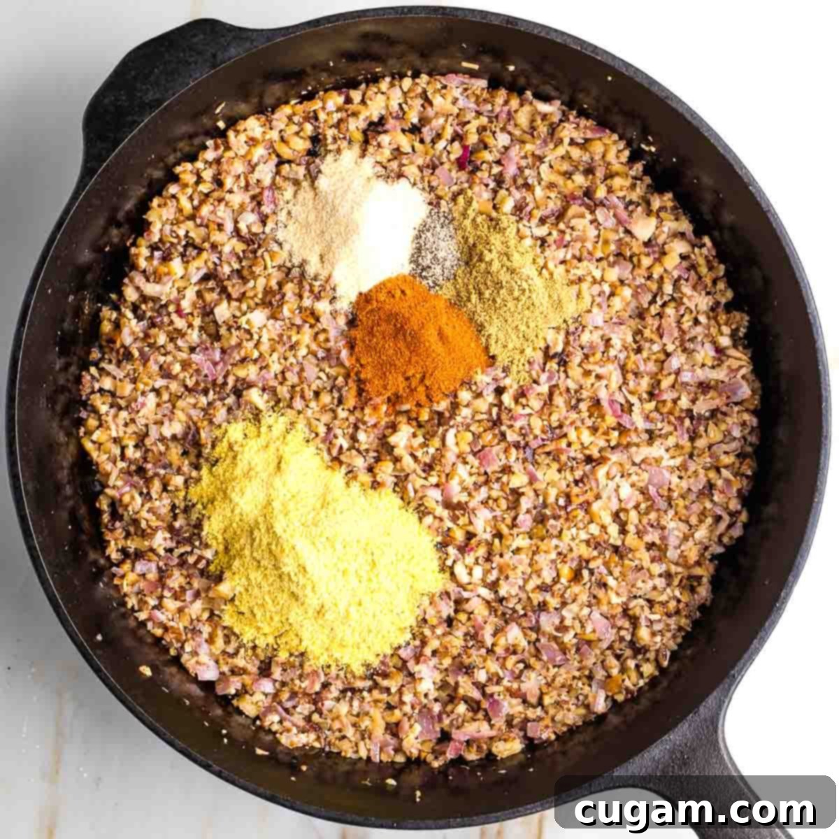 Adding spices to sautéed vegetables.