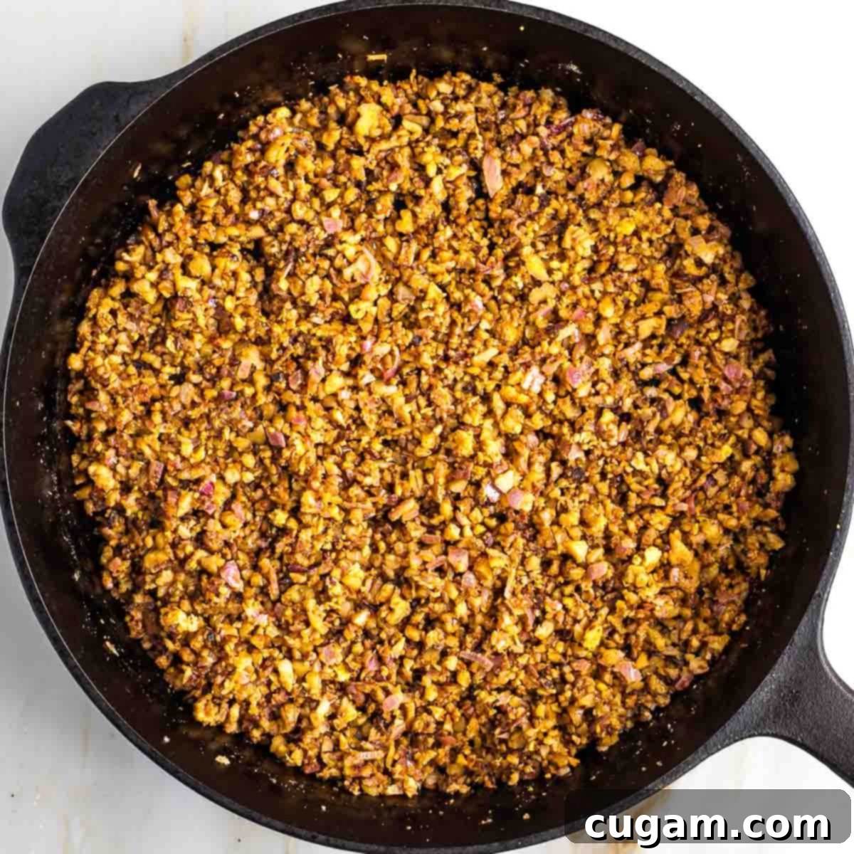Stirring spices into the vegetable mixture.