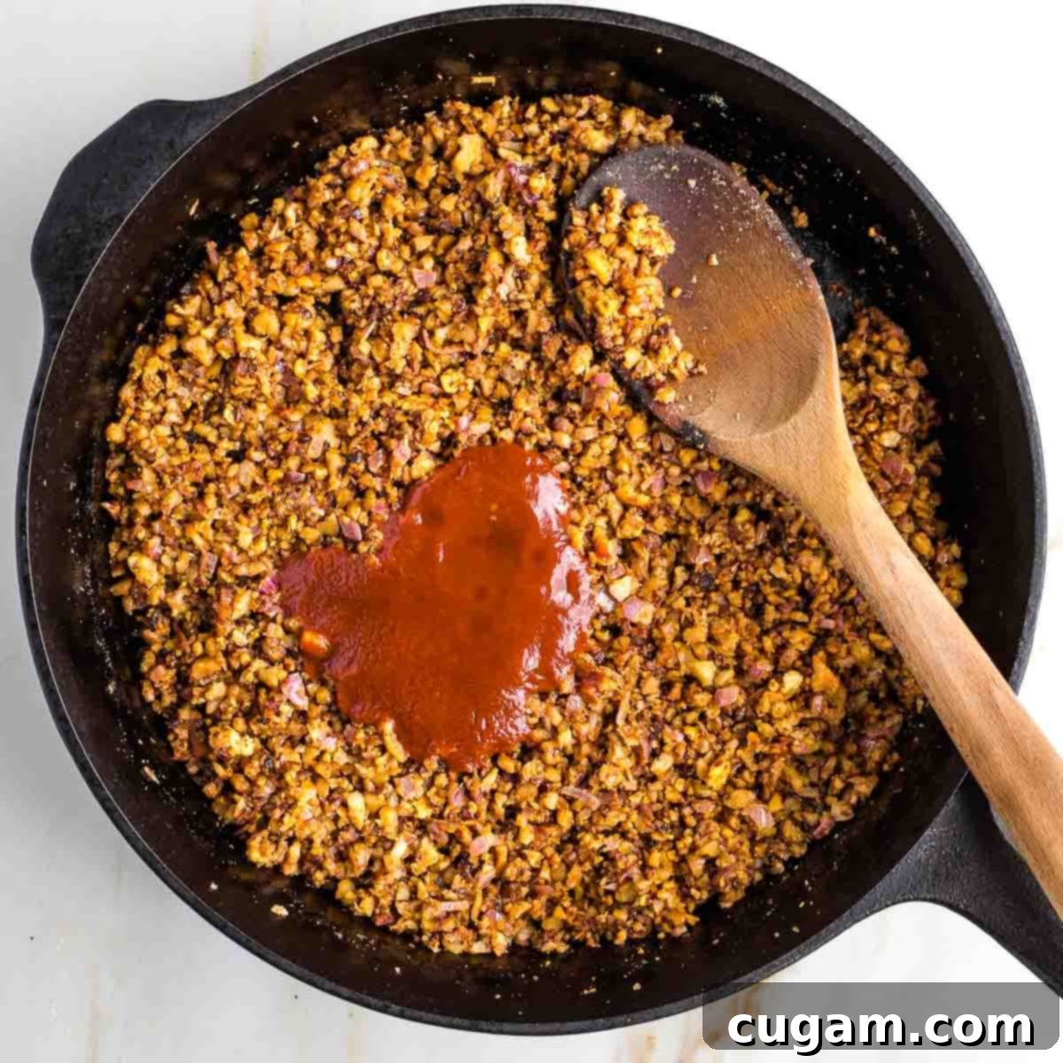 Adding liquid mixture to the skillet.