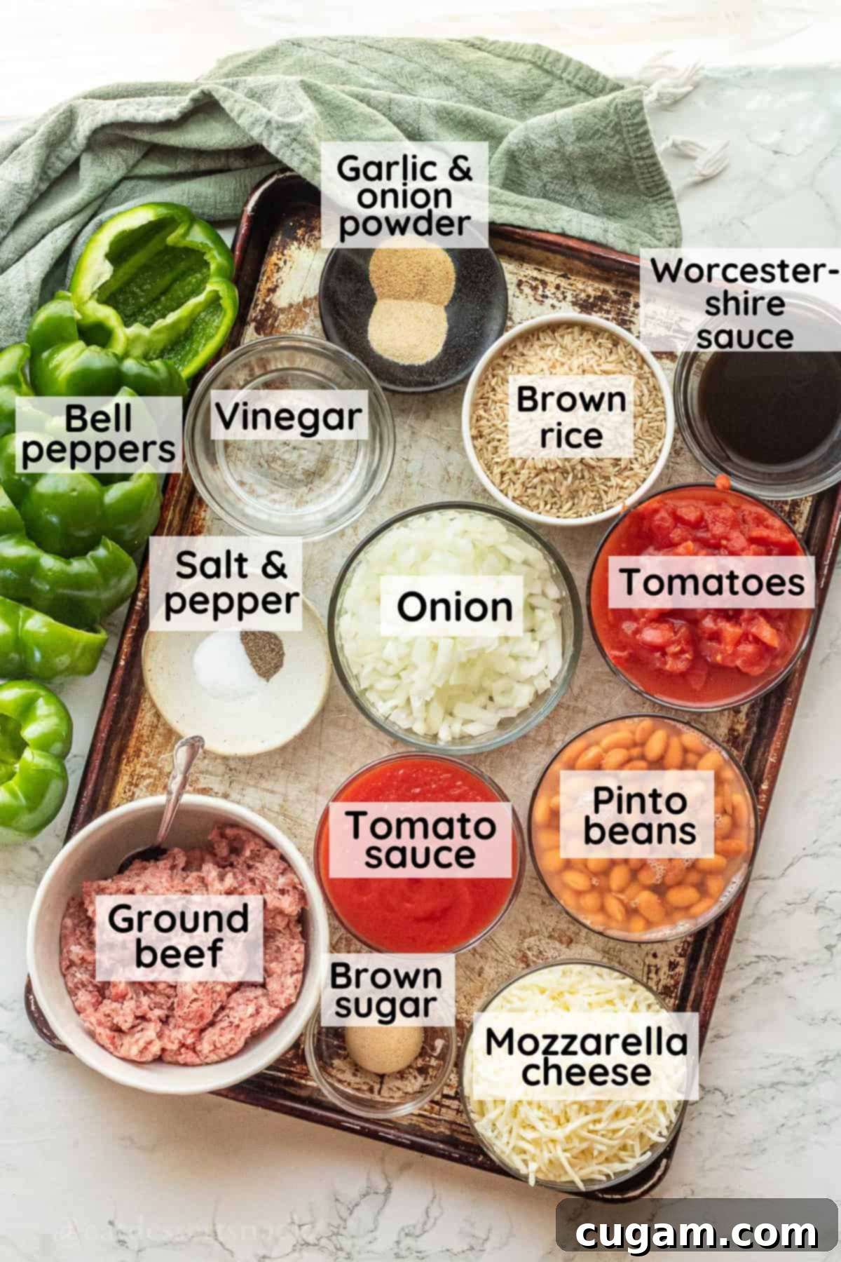 Savory Ground Beef and Rice Stuffed Peppers 2 Labeled Ingredients for ground beef stuffed bell peppers in glass dishes on metal pan, ready for cooking.