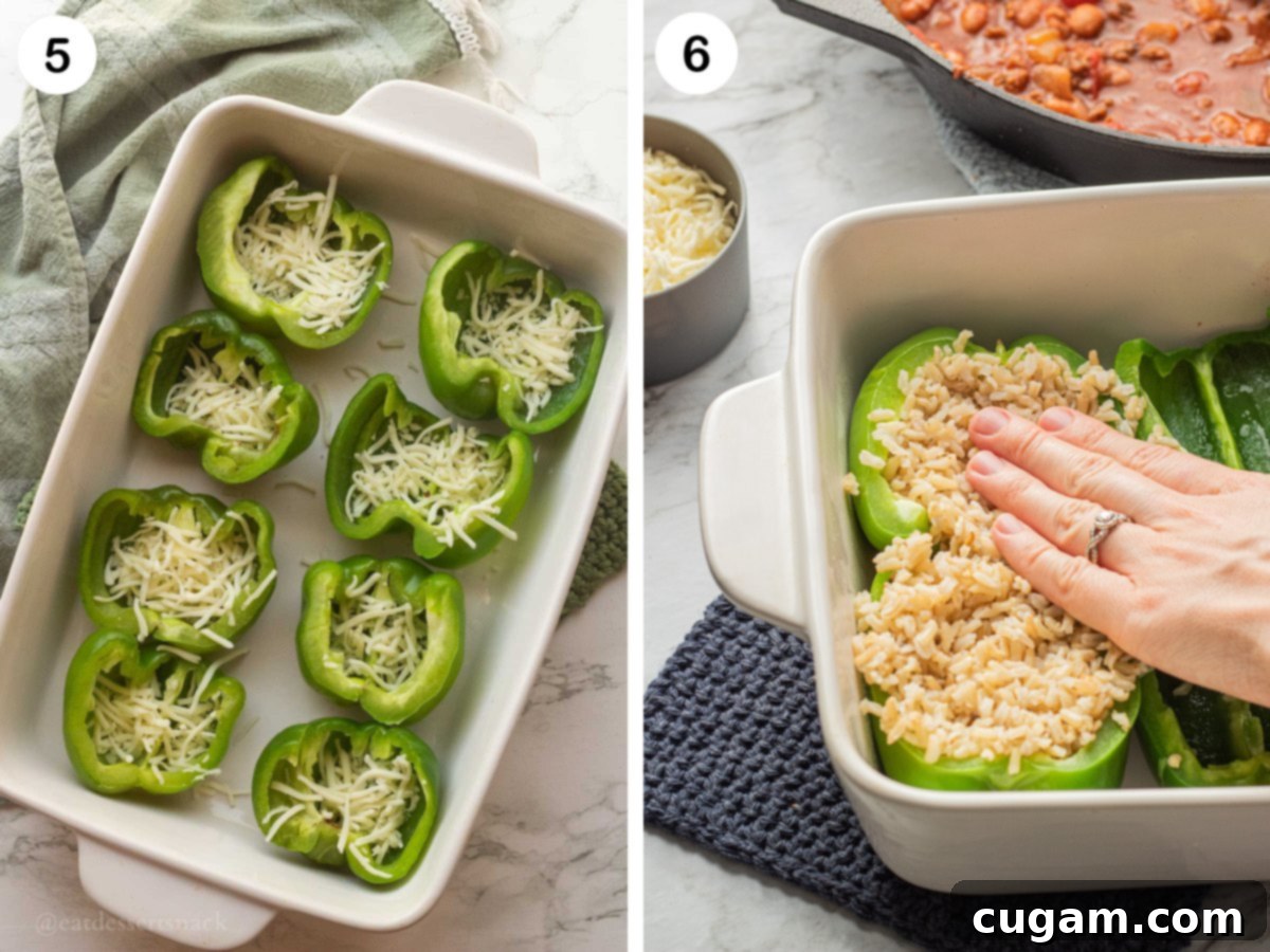 Savory Ground Beef and Rice Stuffed Peppers 5 Green pepper halves layered with cheese in a white baking pan, and a hand pressing cooked rice into another pepper half.