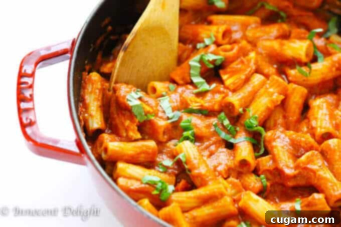 Delicious Chicken Tomato Basil Rigatoni pasta, garnished with fresh basil leaves.