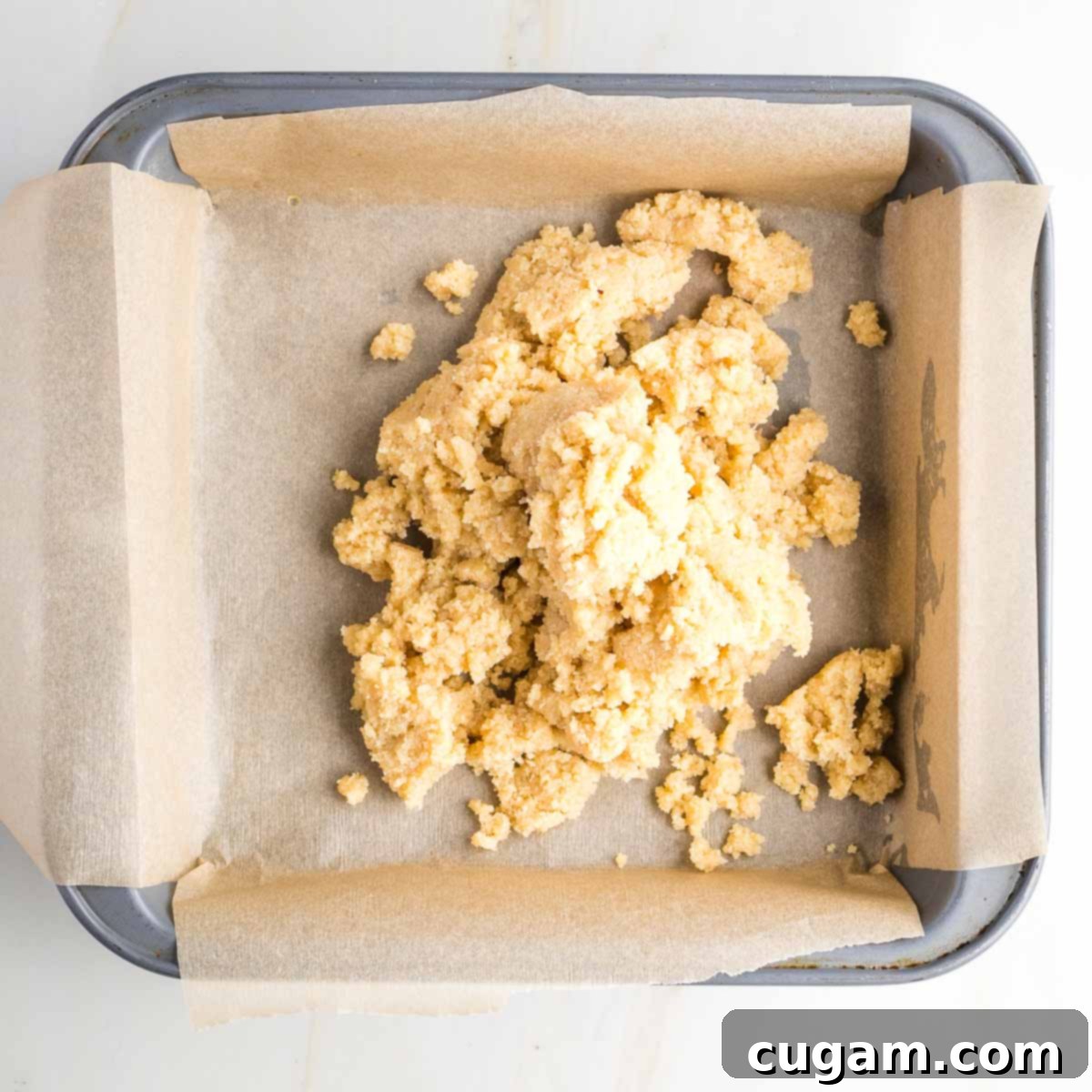 Cookie dough turned our into a square pan lined with parchment.