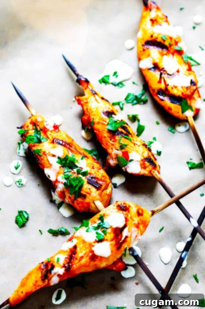 Honey Harrisa Chicken Skewers with Garlic Mint Sauce - amazing combination of Mediterranean flavors in these super tasty skewers with a dollops of refreshing garlic mint sauce. My guests couldn't get enough.