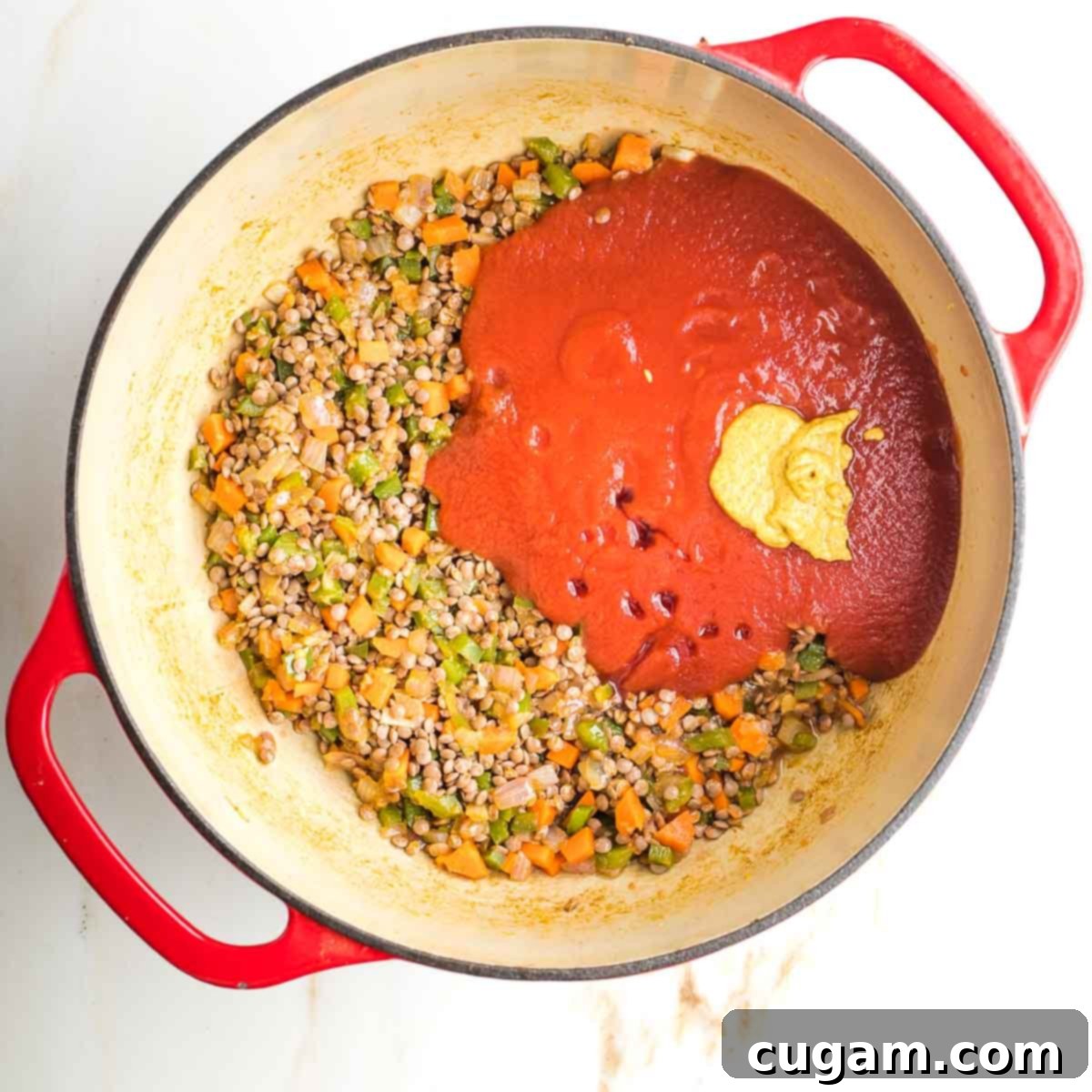 Lentils and sauteed veggies with tomato sauce, mustard and maple syrup on top.