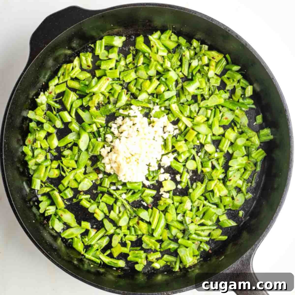 Sauteed broccolini stems in a cast iron with a couple tablespoons minced garlic in the middle. 