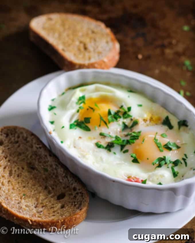 Baked eggs with juicy tomatoes and crumbly feta cheese, served hot.