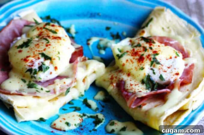 Easy Crepes Eggs Benedict featuring delicate crepes, poached eggs, and creamy Hollandaise sauce.