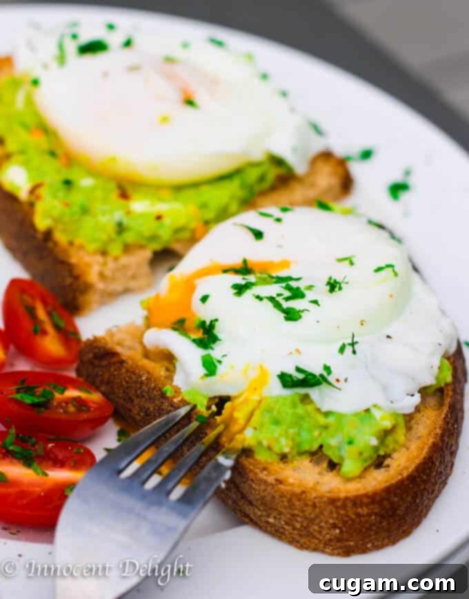 Smashed avocado toast topped with a perfectly poached egg.