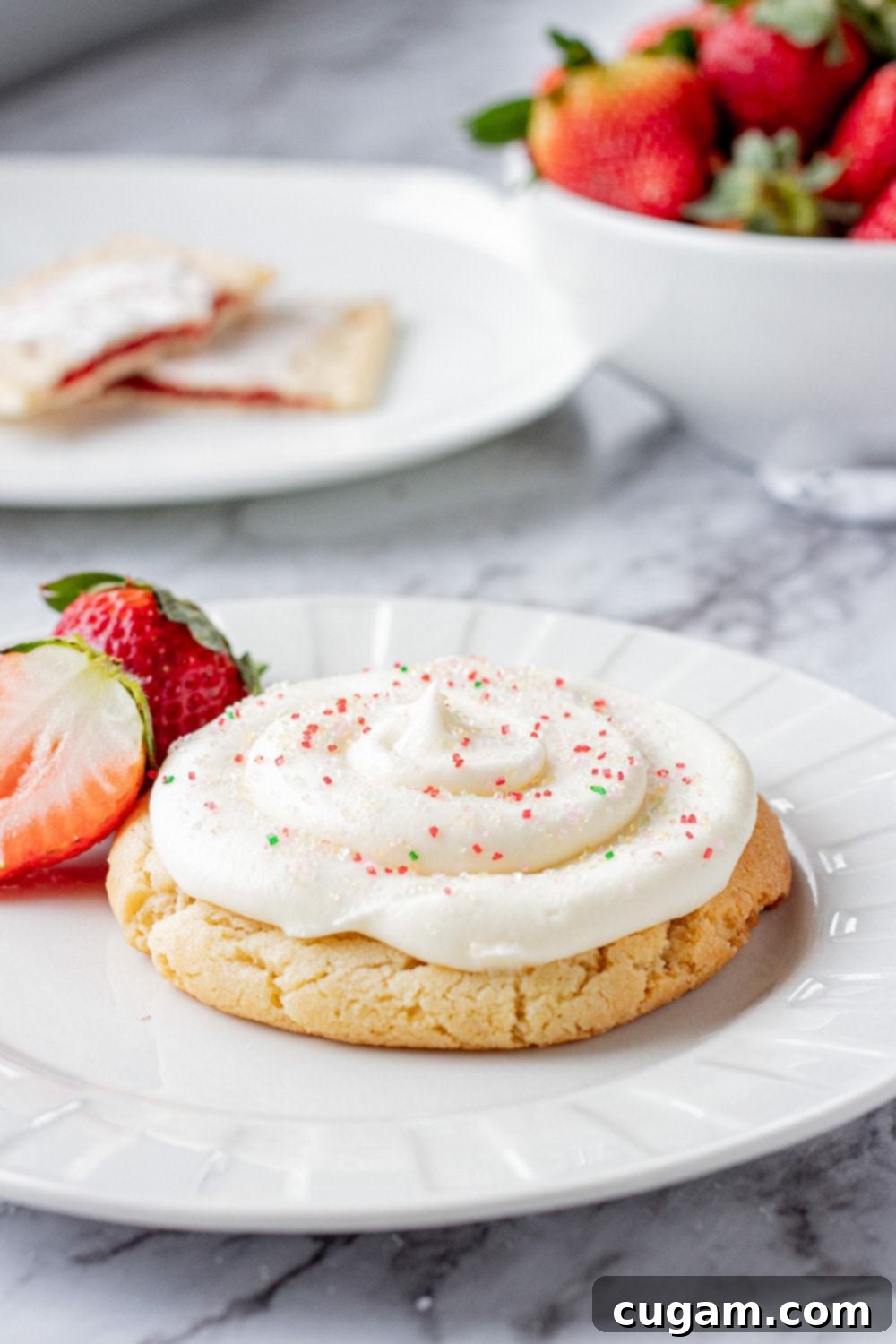 Baked strawberry pop tart cookies on a white plate with strawberries. 