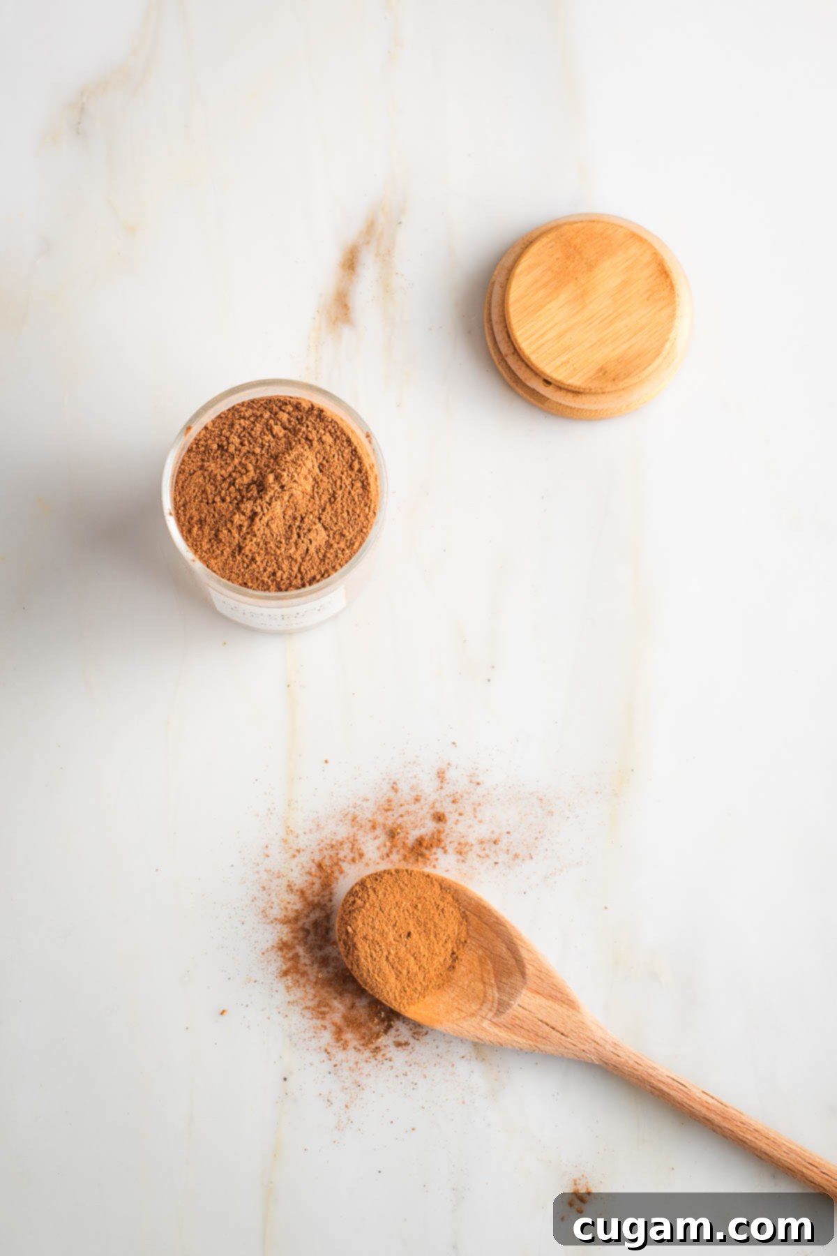 Mixing individual spices in a small jar to create pumpkin pie spice.