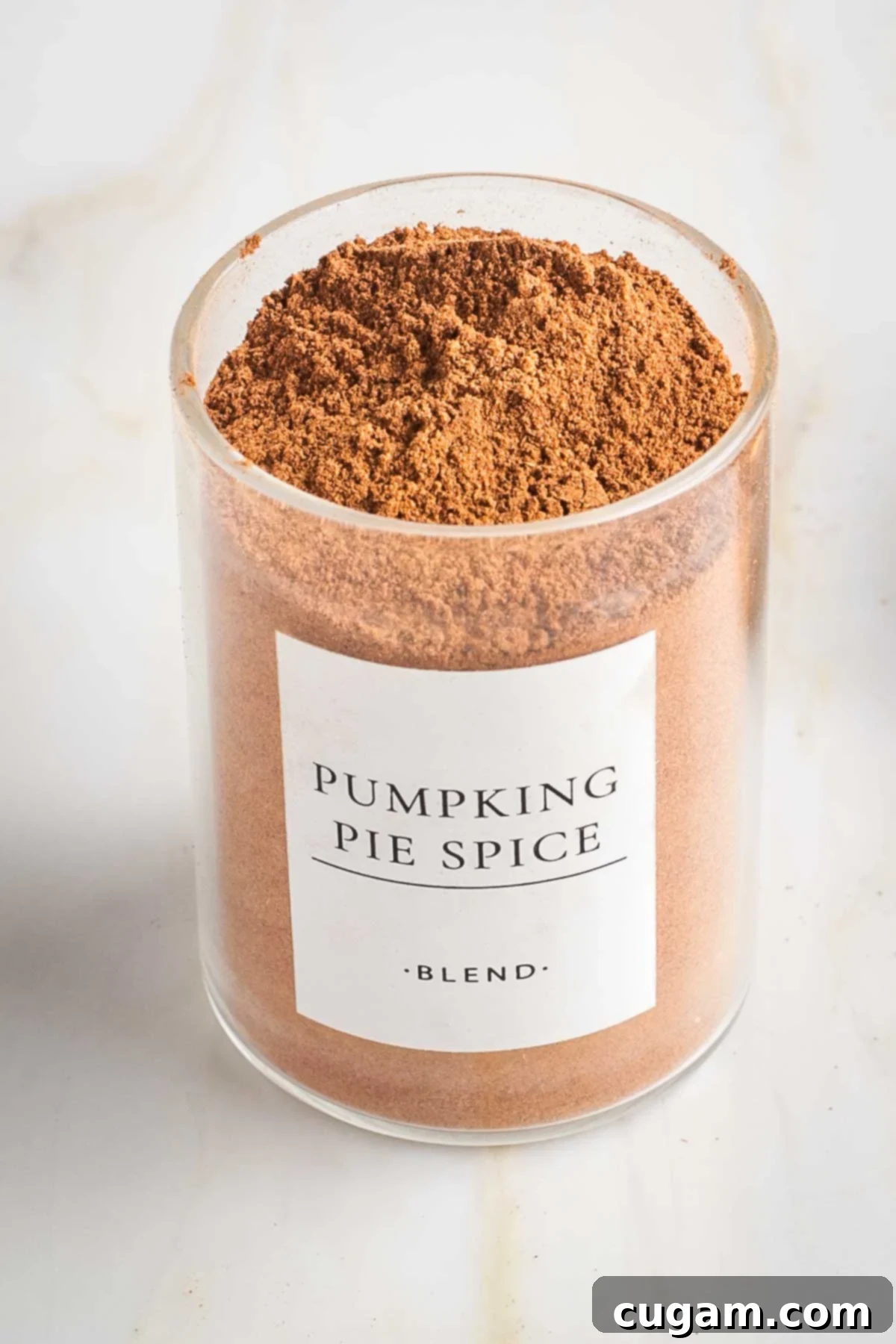 Small spice jar with brownish orange powder labeled "pumpkin Pie Spice"