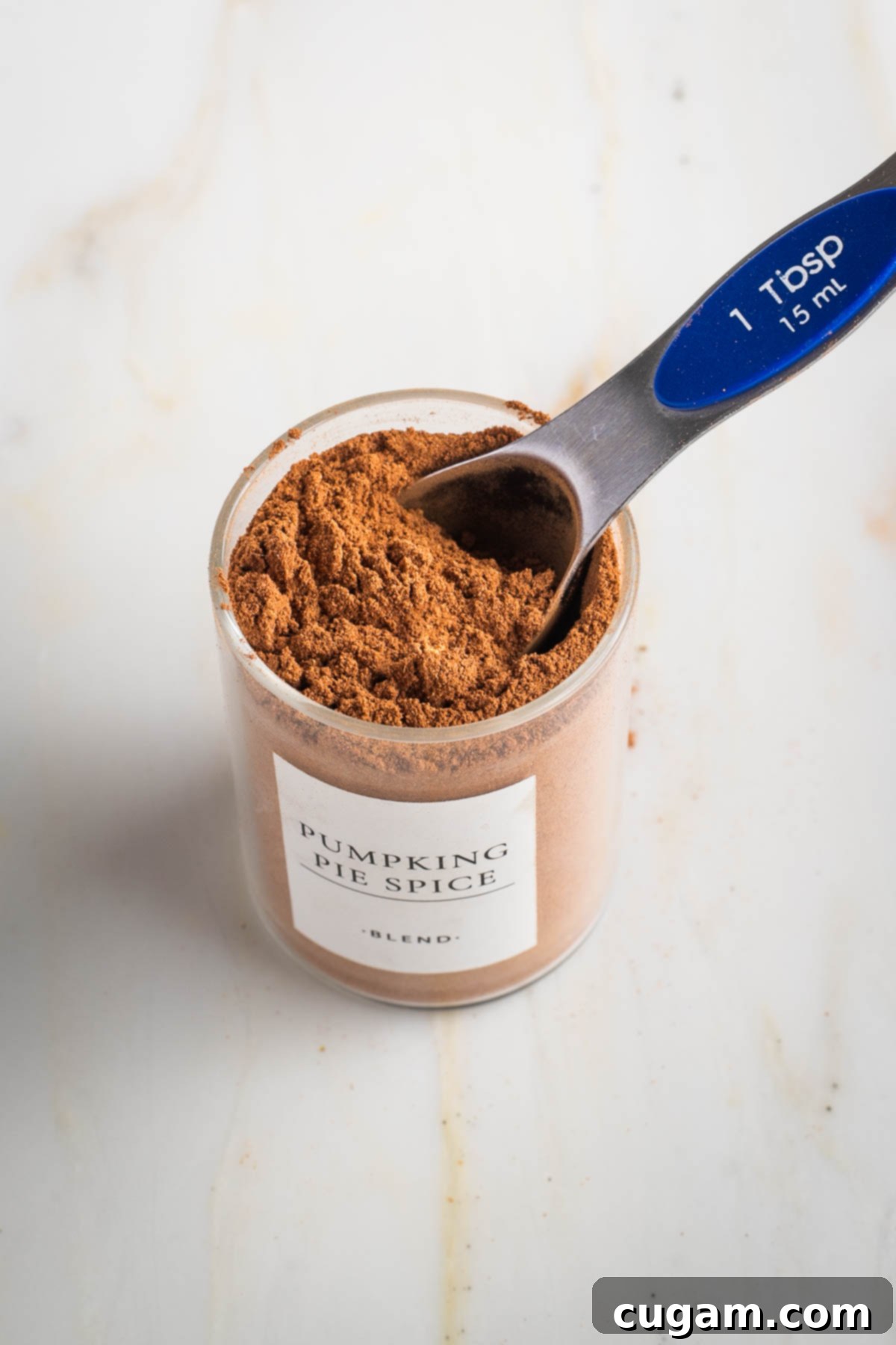 Small jar of spice mixture with label "pumpkin pie spice" on it.