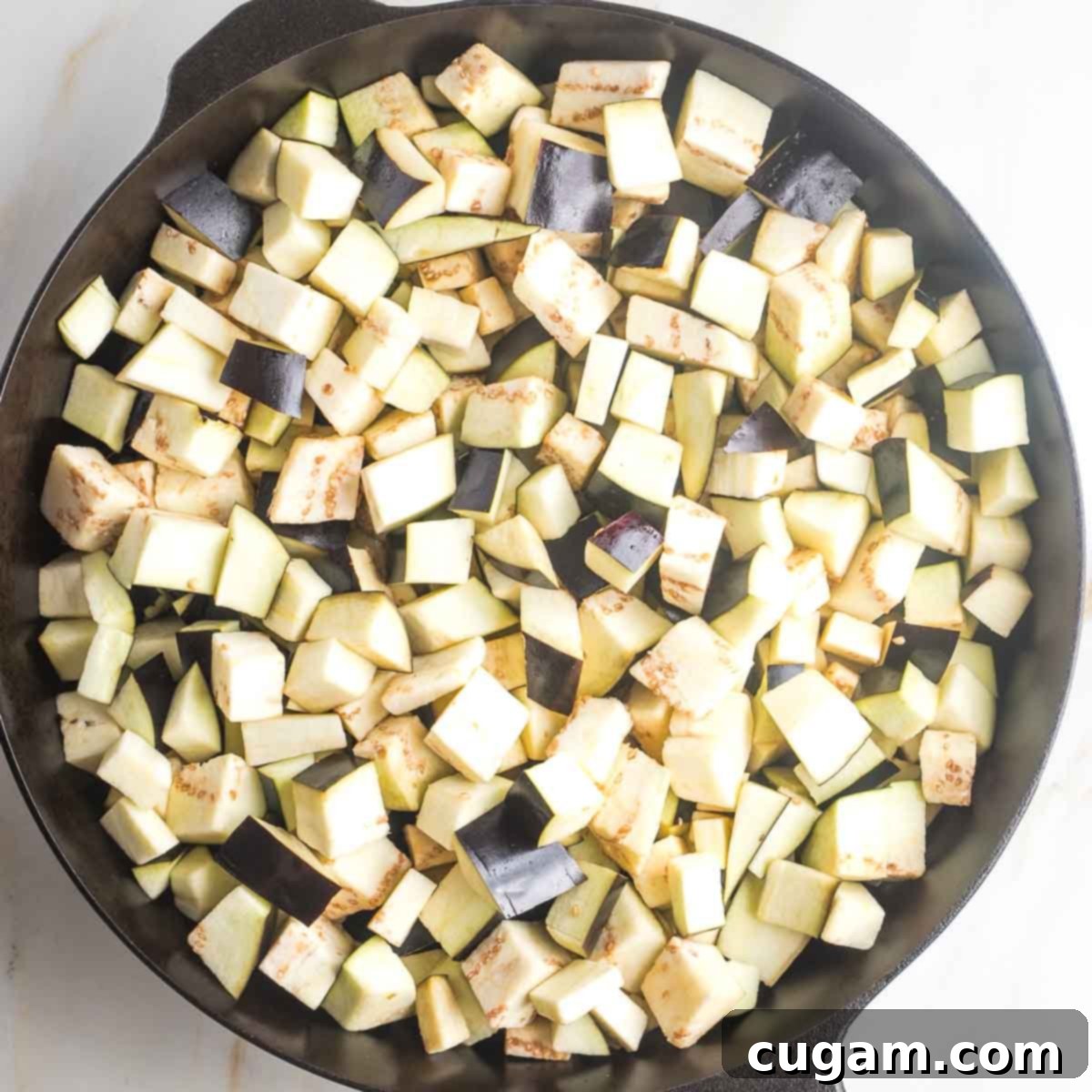 Pan-Fried Eggplant Salad 10 Small cubes of eggplant starting to sauté in a hot cast iron skillet.
