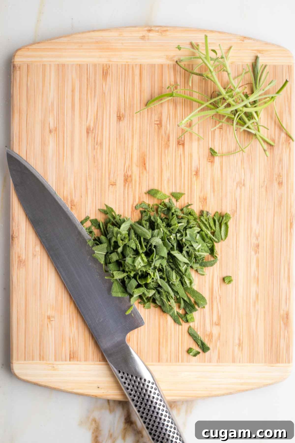 Fresh sage leaves stacked and roughly chopped.