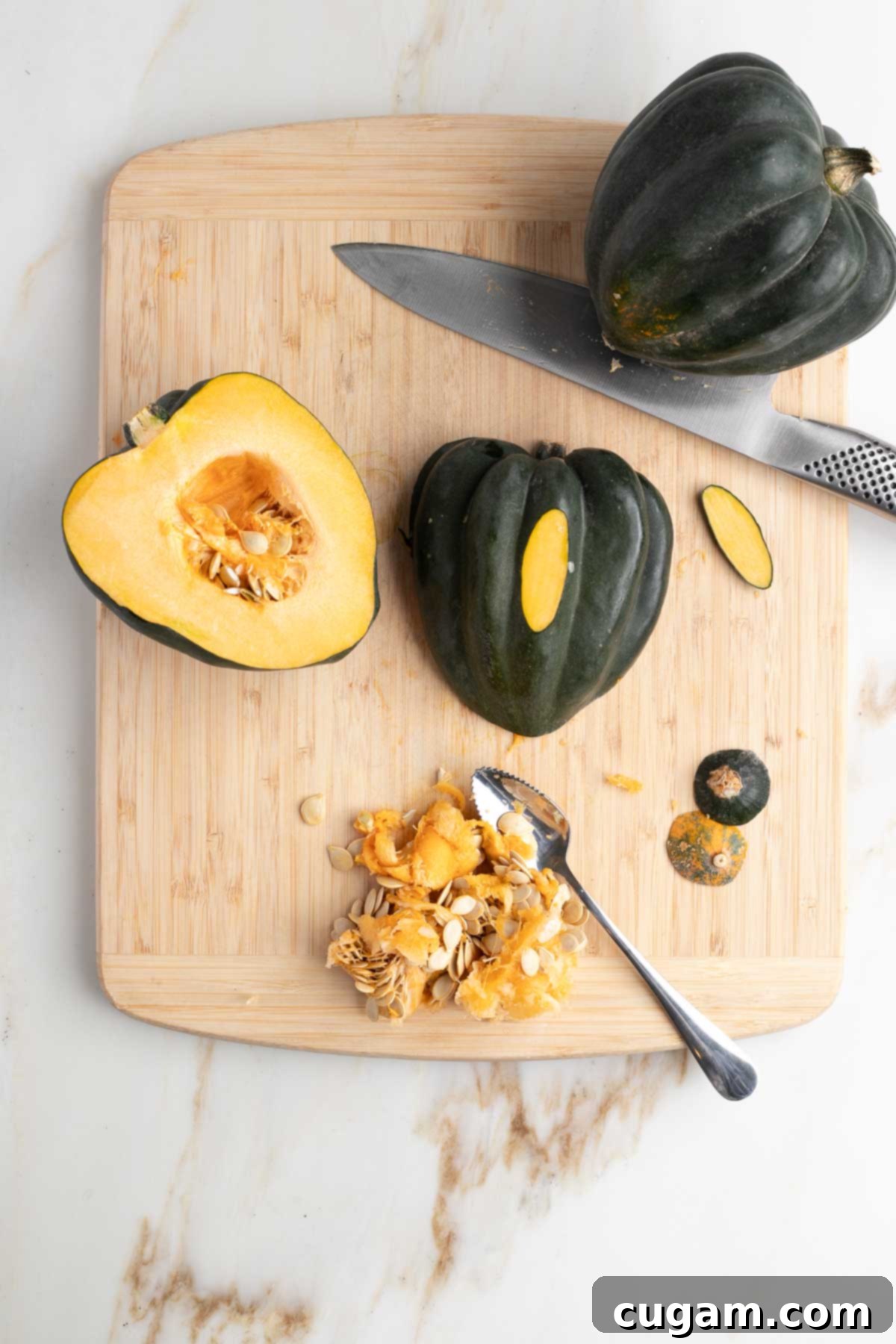 Acorn squash cut in half, seeds scooped out and a sliver cut off the outside so it will sit flat.
