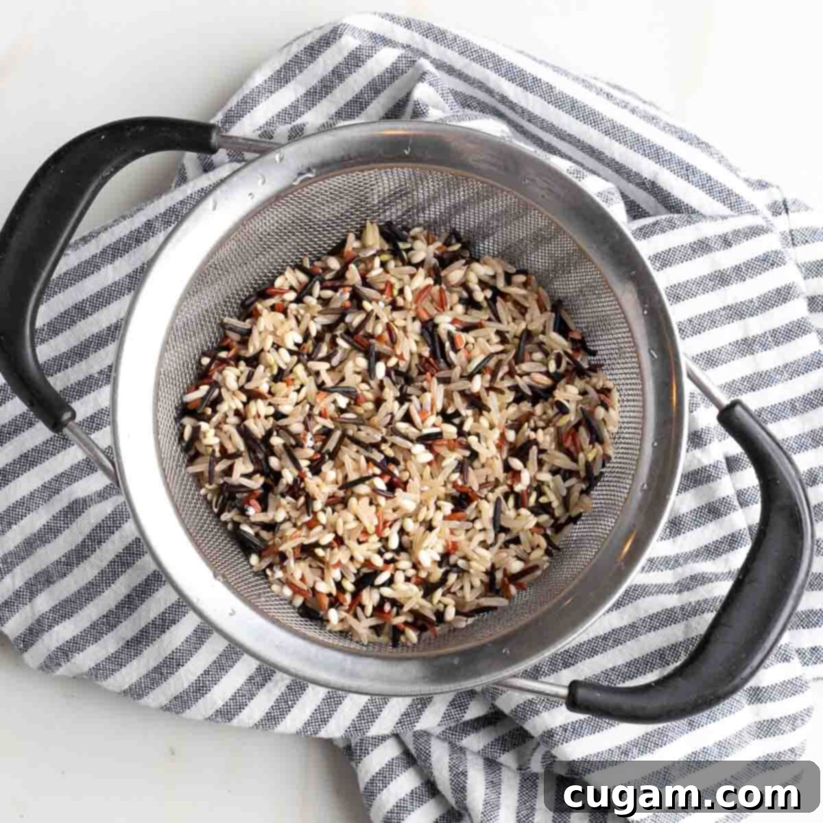 Wild rice being rinsed under cool water.