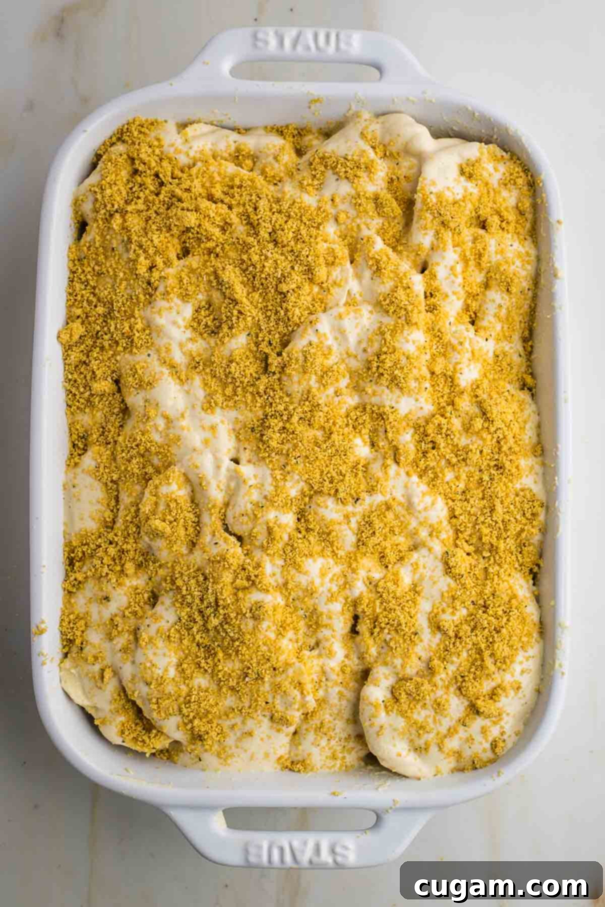 Thinly sliced parsnips with sauce and parmesan sprinkled on top.