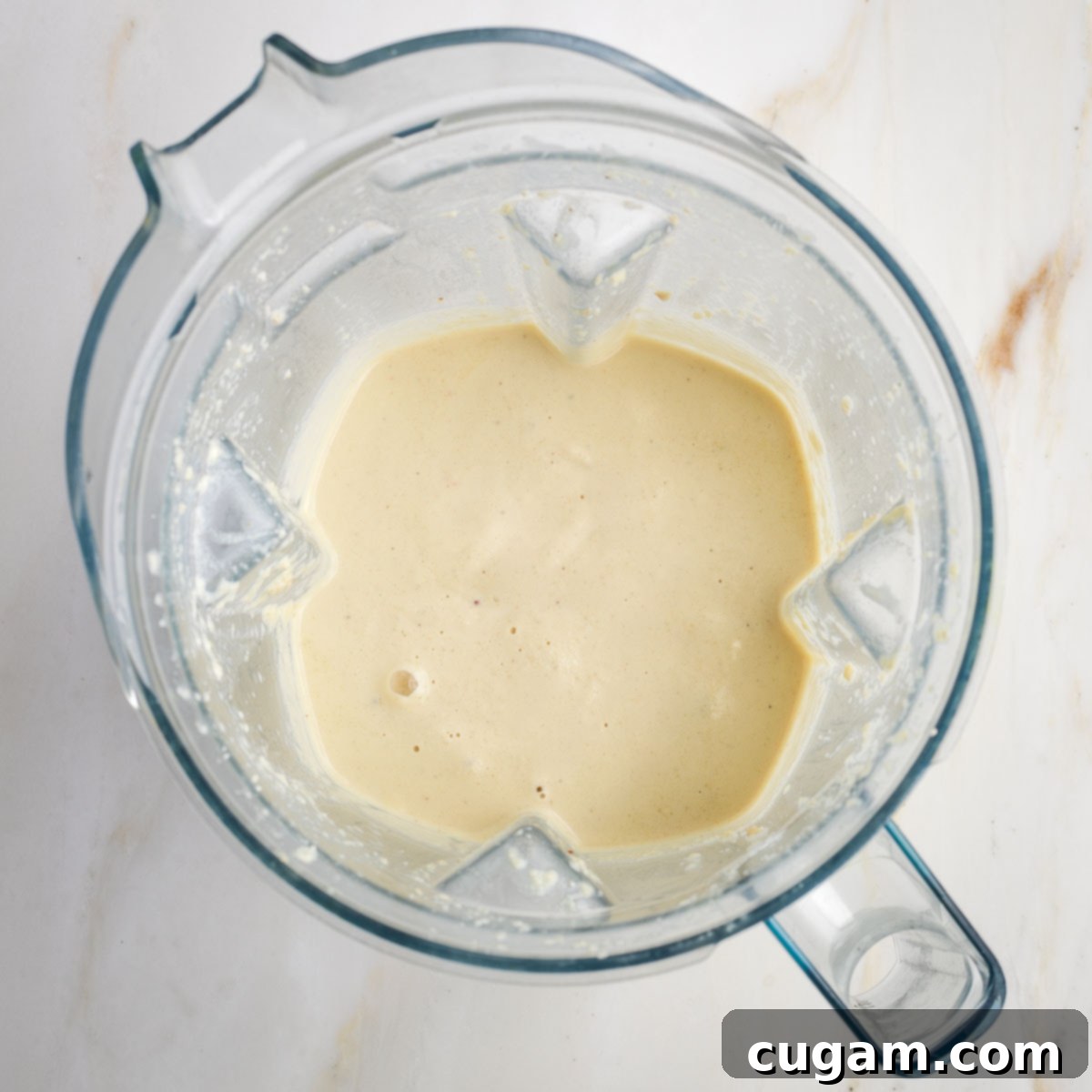 Beige, creamy sauce in a blender.