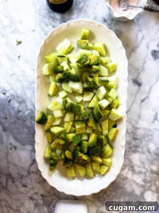 Cubed avocado pieces beautifully arranged on top of the cucumber base for the creamy cucumber avocado feta salad.