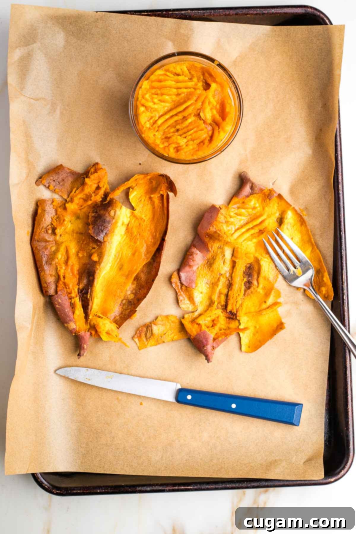 Baked sweet potatoes, sliced open and mashed with a fork.
