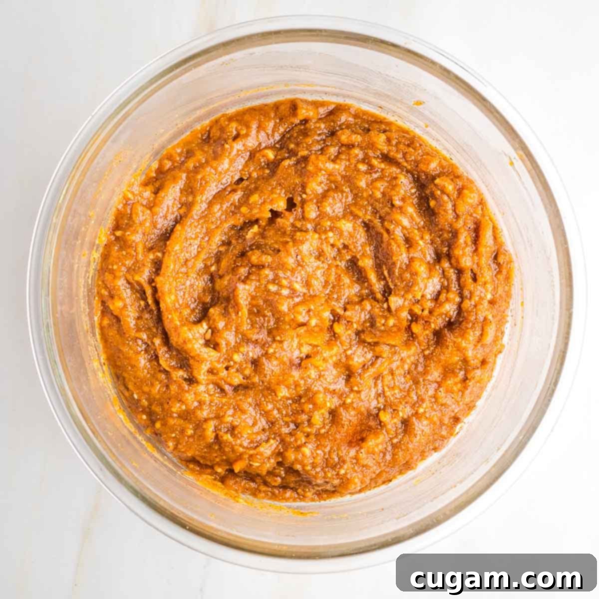 Orange brown mixture in a glass bowl. 