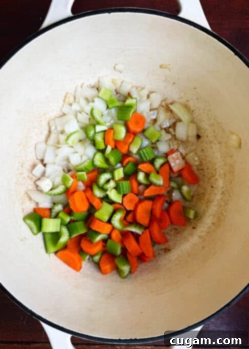 Sautéed onions, carrots, and celery in a soup pot