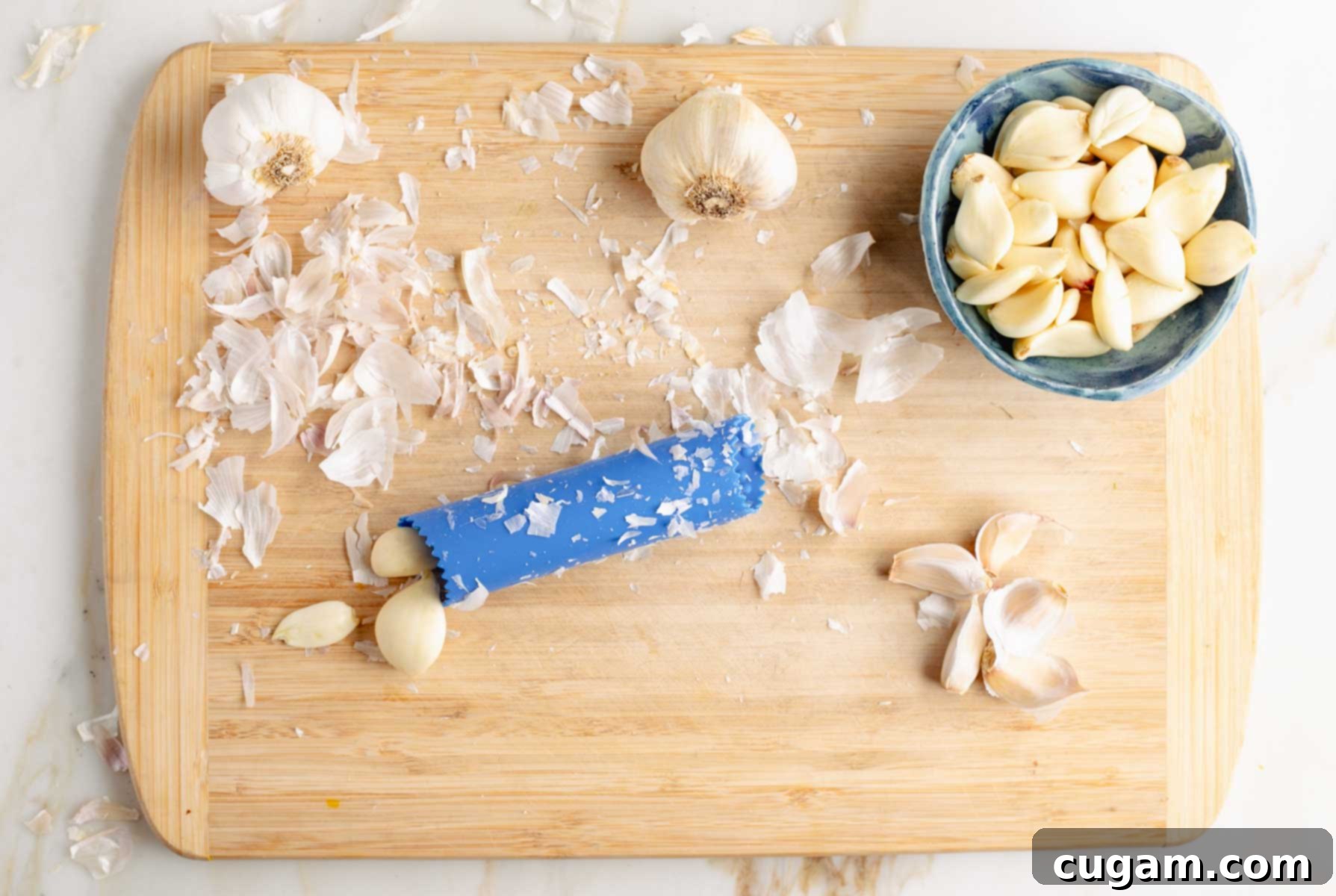 Rolling cloves of garlic to peel and put into a small bowl. 