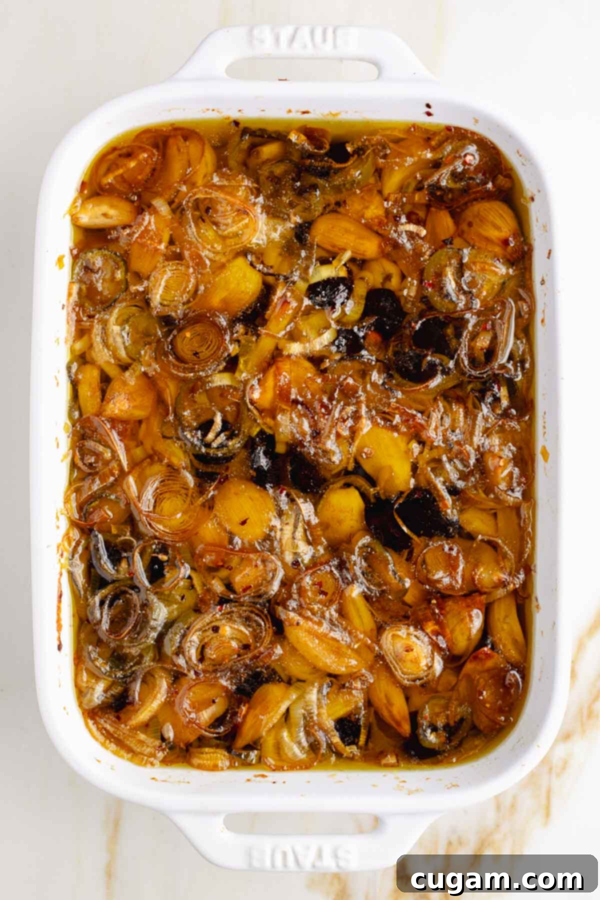 Golden brown garlic cloves, leeks, jalapenos and cherries in olive oil. 