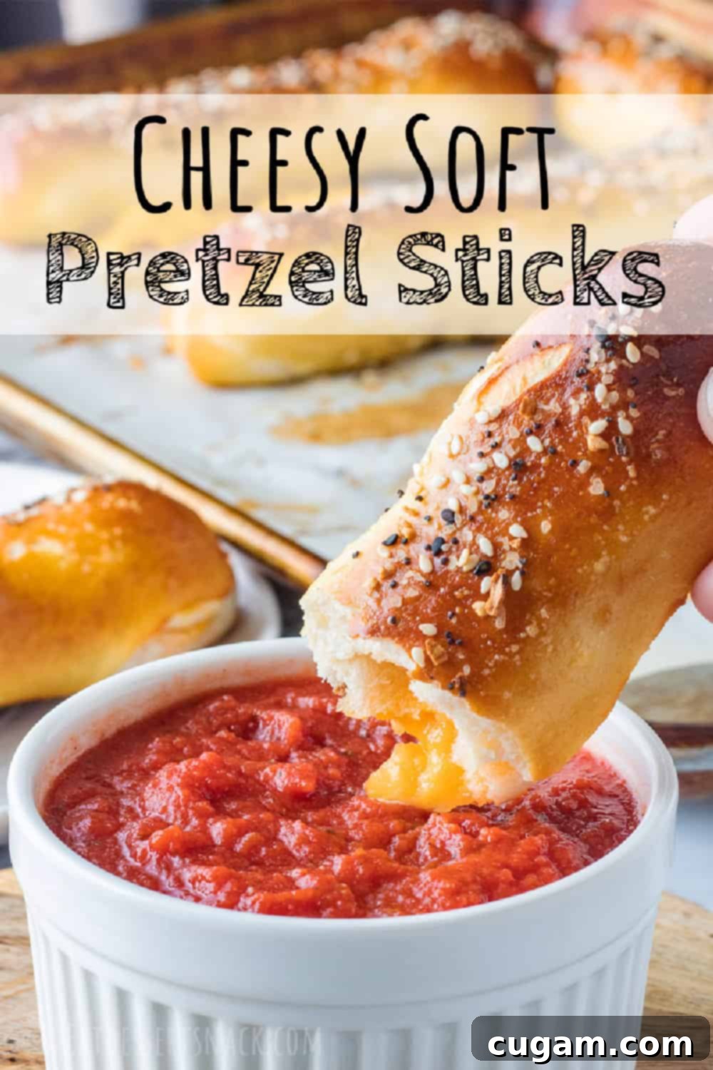 Baked Pretzel above white bowl of red sauce. Text overlay. 