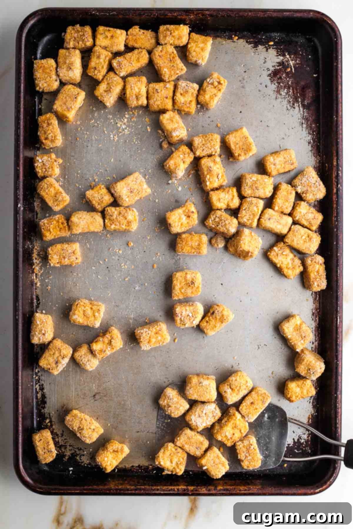 Crispy cubes of tofu on a sheet pan. 