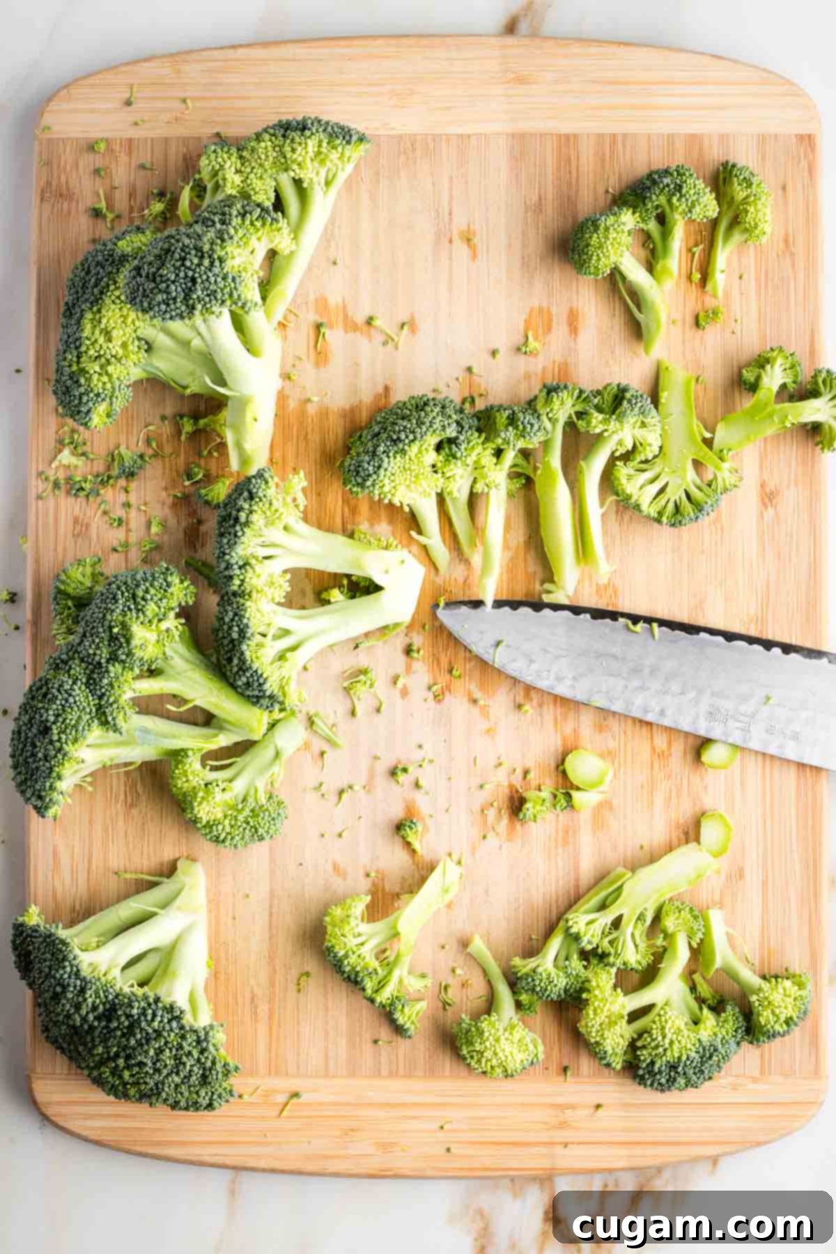 Trimming a crown of broccoli into florets.