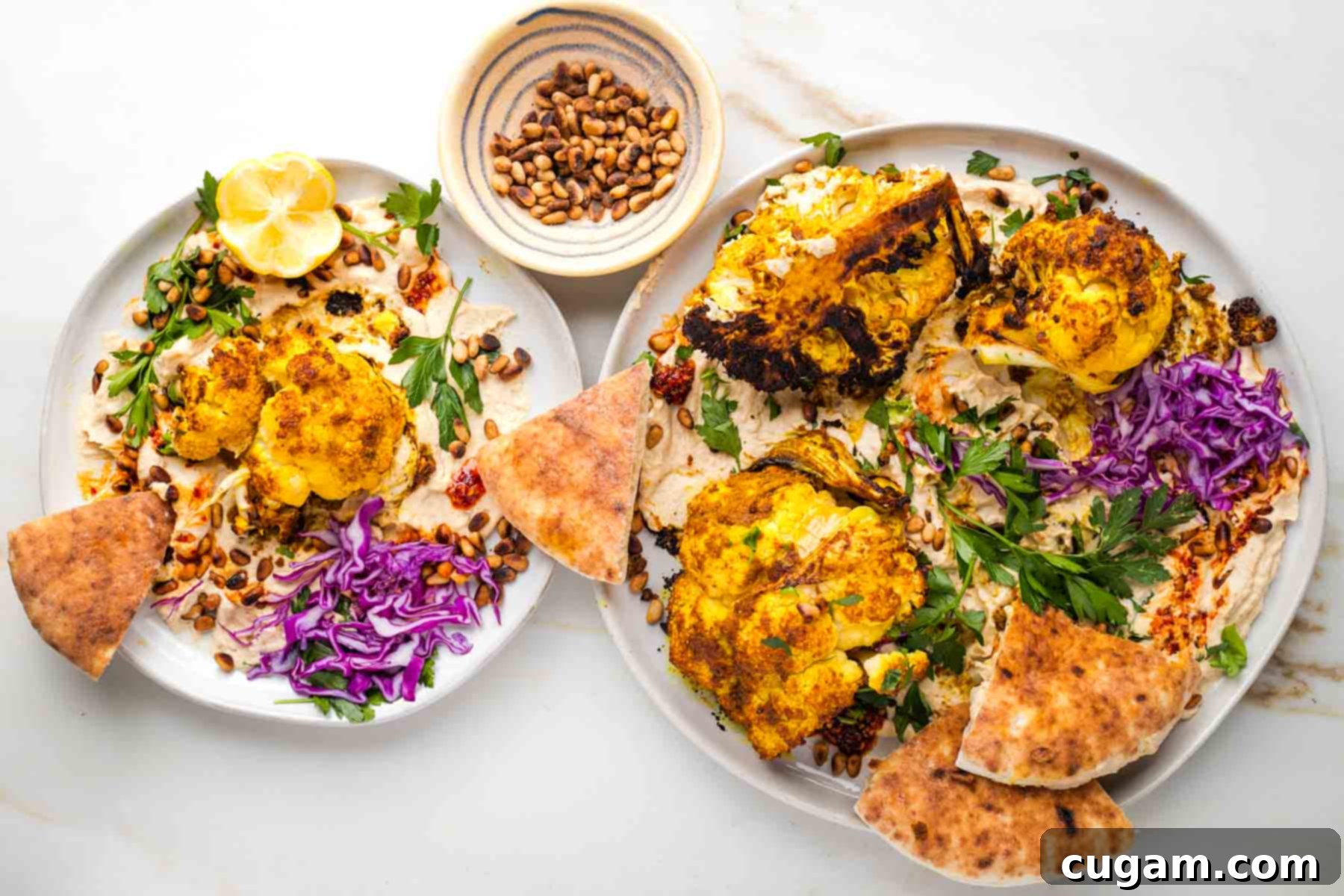 Roasted cauliflower on top of hummus with chili oil, toasted pine nuts, pita, fresh parsley and cabbage. 