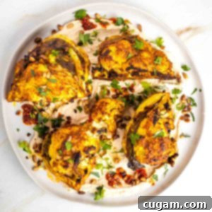 Crispy roasted cauliflower on a bed of hummus, sprinkled with more spices, pine nuts and fresh herbs.