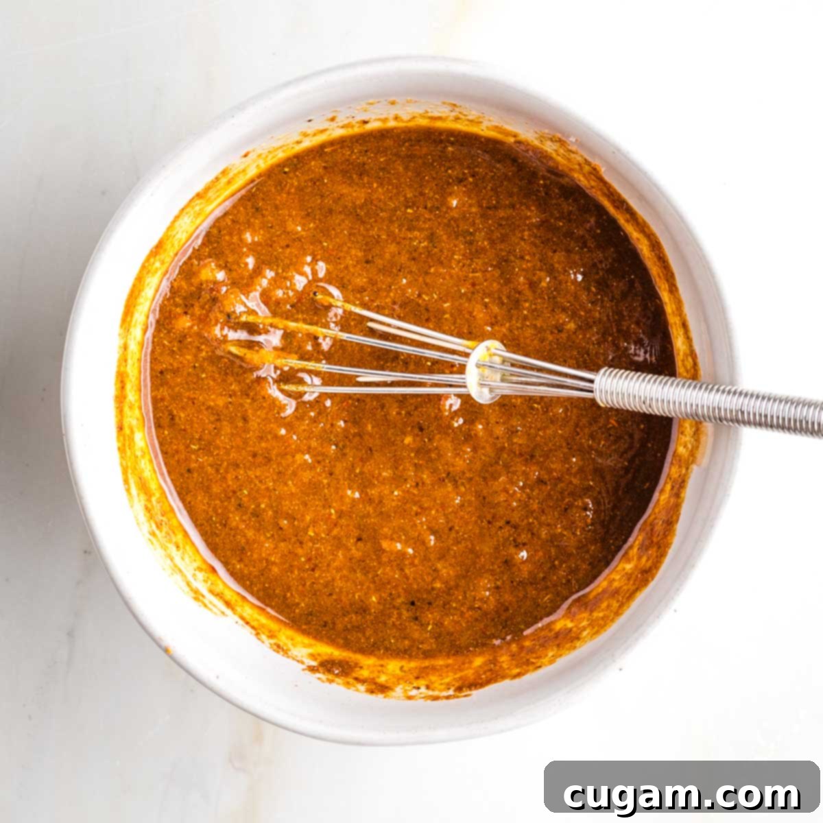 Thick, rust colored pasty spice mixture.