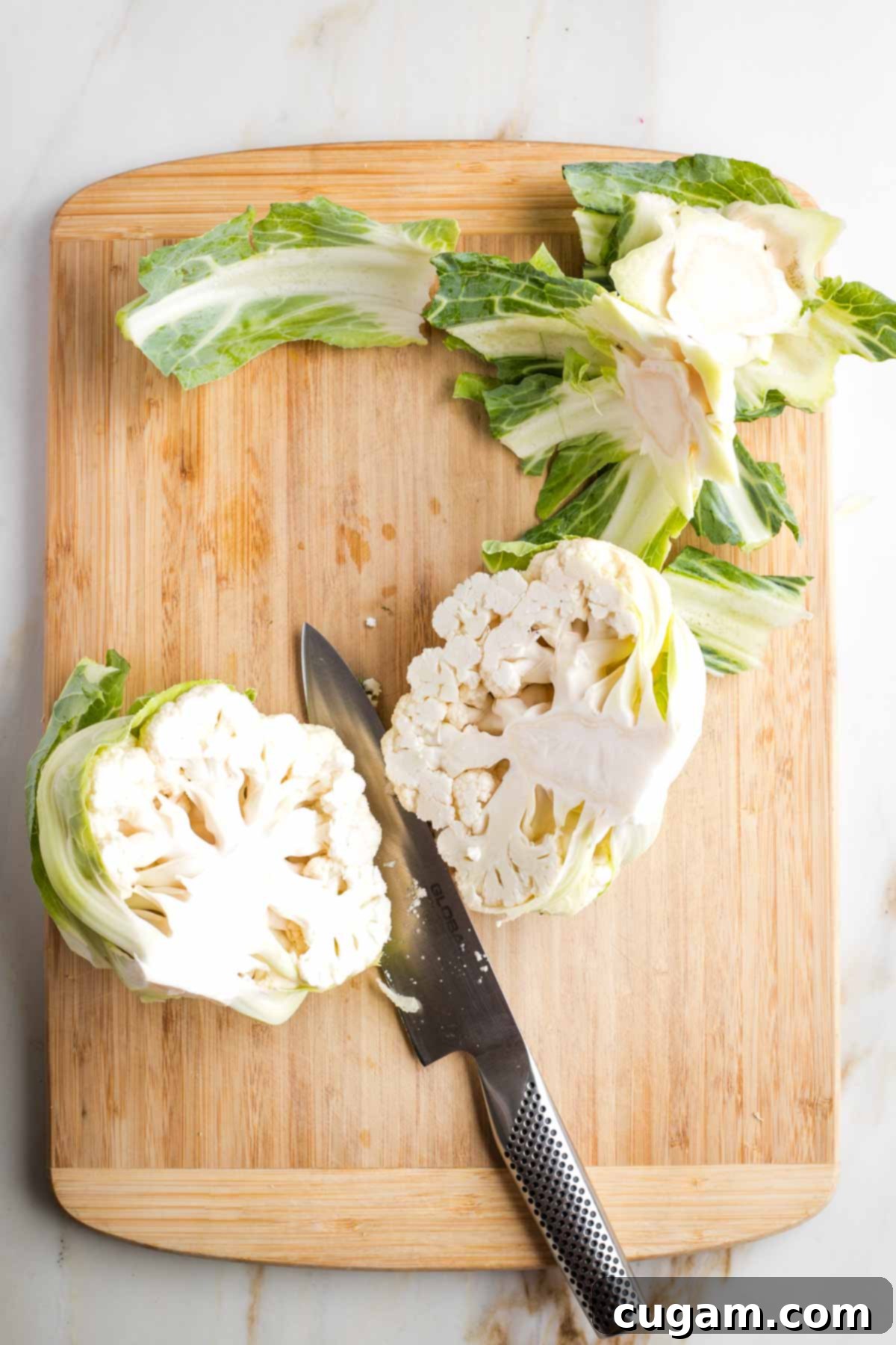 Head of cauliflower, leaves trimmed off, cut in half through the core.