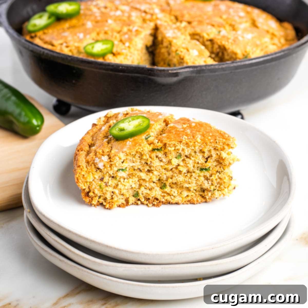 Side view of a slice of cornbread with jalapenos.