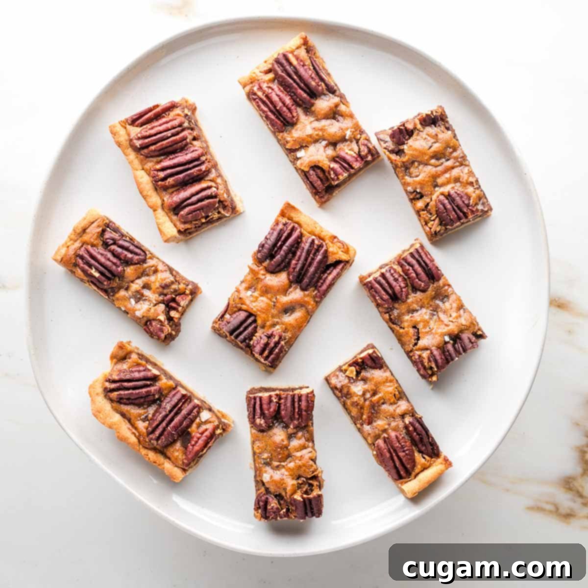 Rectangular slices of pecan pie bars on a round plate. 