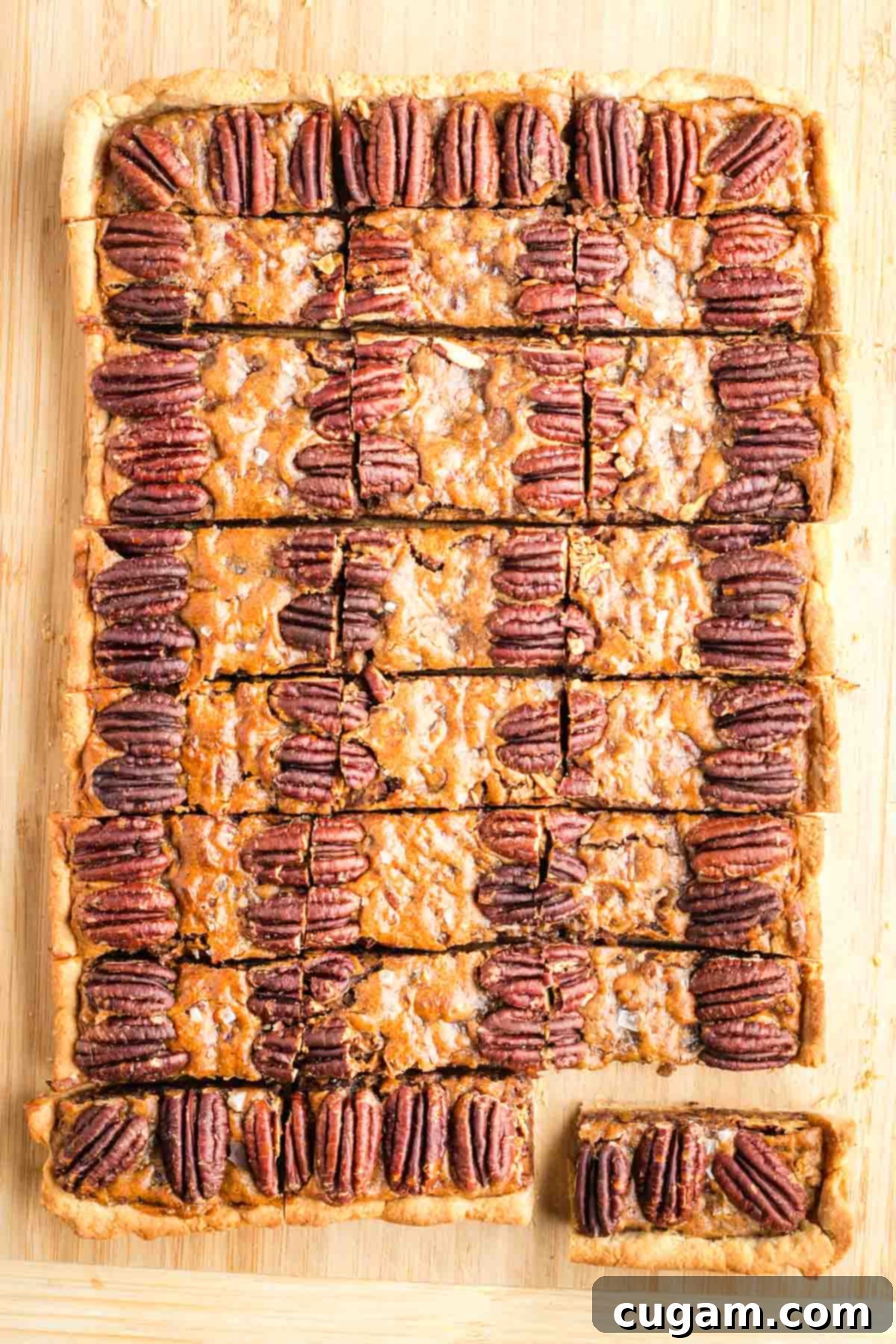 Large rectangle pecan pie cut into small pieces. 