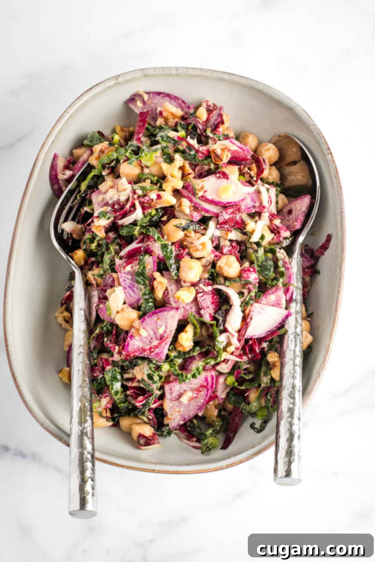 Vibrant Radicchio Chickpea Salad with Tahini 2 Colorful chopped salad with radicchio, kale, purple radish, chickpeas and walnuts, all tossed in a creamy tahini dressing.