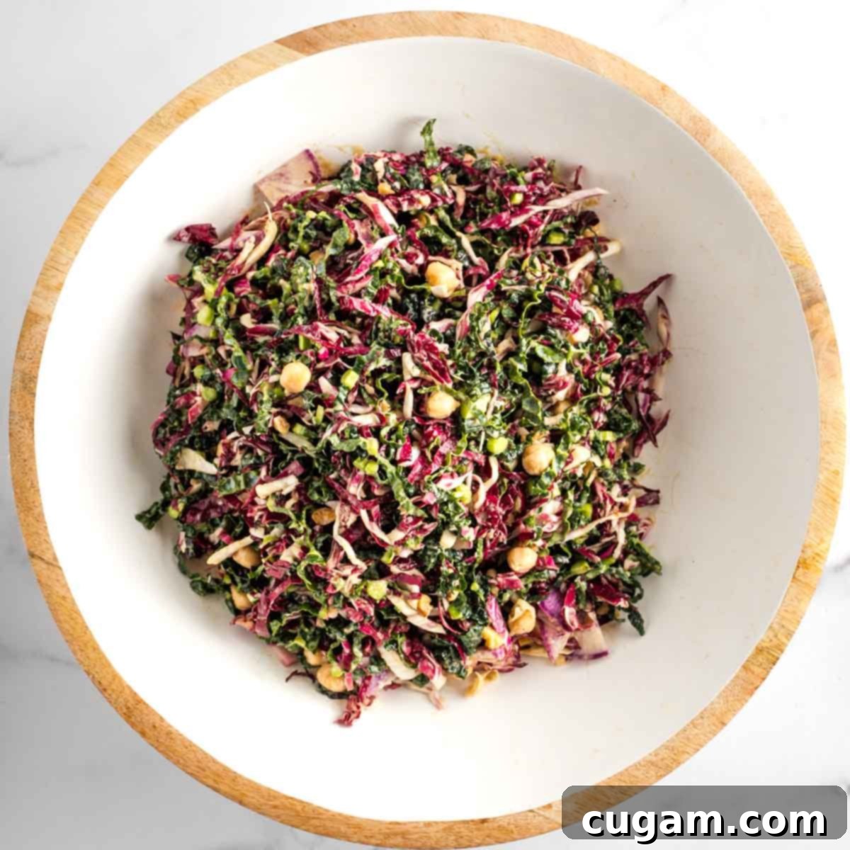 Vibrant Radicchio Chickpea Salad with Tahini 16 Chopped radicchio salad with kale, radish, chickpeas and walnuts.